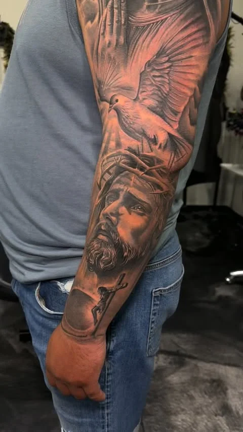 Cover up of old Jesus portrait on upper arm by Alex Zamora